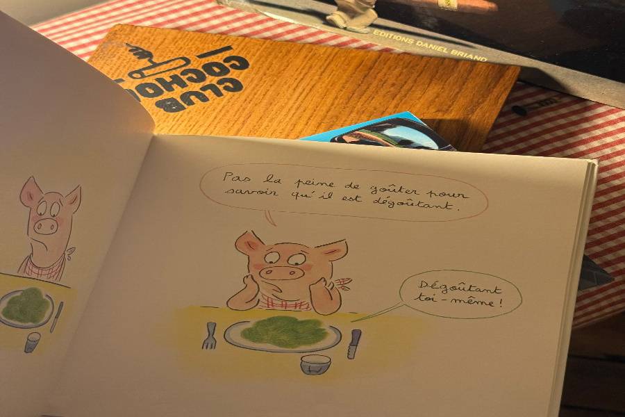 Comic book showing a pig not wanting to eat salad.