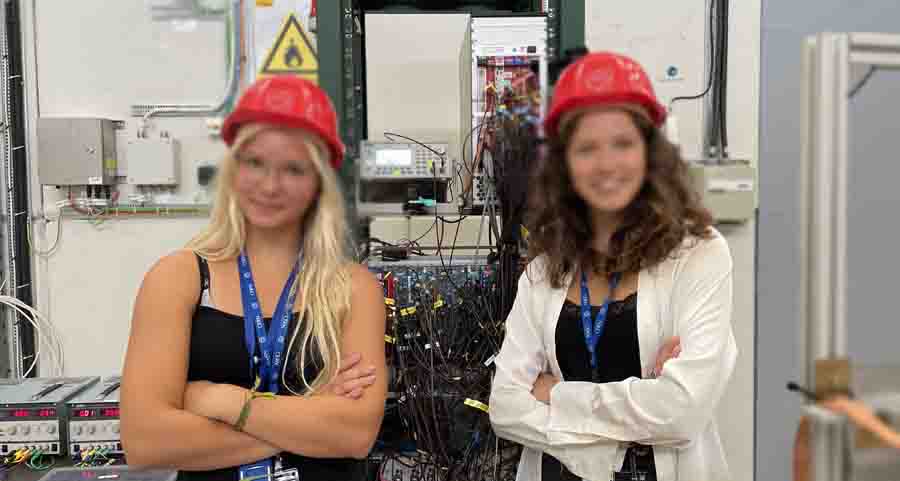 Girls posing happy wearing red helmets