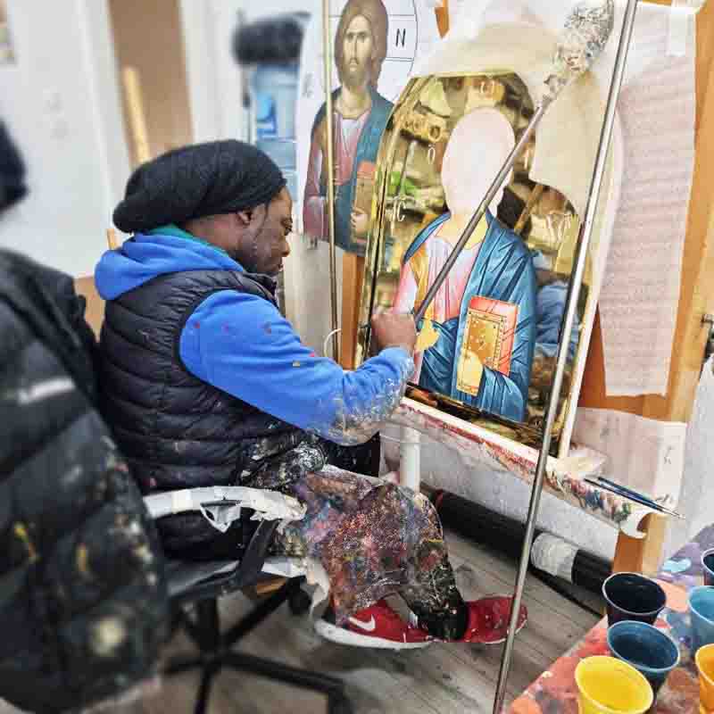 Chrys Mbenga painting in his atelier